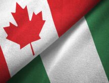 A picture of the Canadian and Nigerian flags draped across each other.