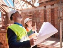 Trades people inspecting a house