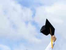 Education. happy students in gowns are celebrating graduation Throwing hands up Graduation Caps in the air, Concept of freedom after the struggles they faced throughout the study.
