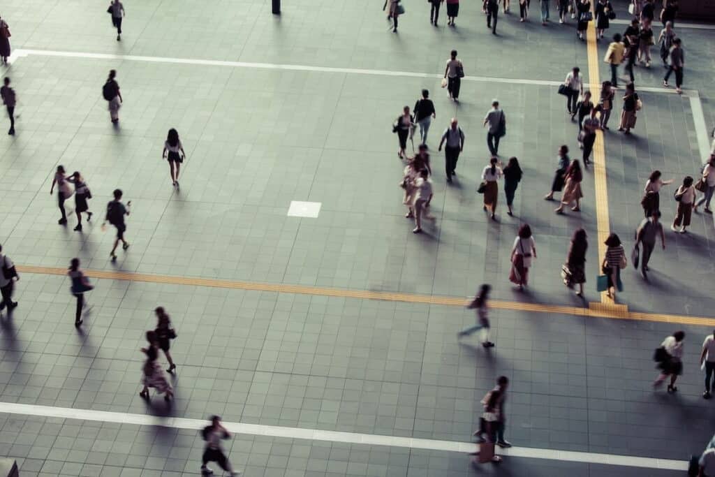 An aerial view showing a scattering of individuals walking all around.