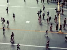 An aerial view showing a scattering of individuals walking all around.