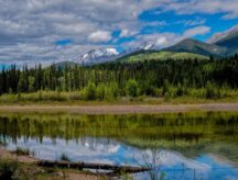 Colorful reflections of the Rocky Mountains are seen in Dog Lake in Kootenay National Park