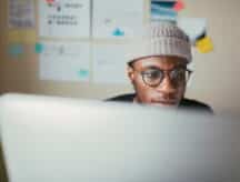 A young man looks at his IEC work permit online.