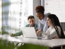 a group of people working in their office abroad.