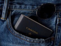A picture of a Canadian passport in the pocket of a pair of jeans.