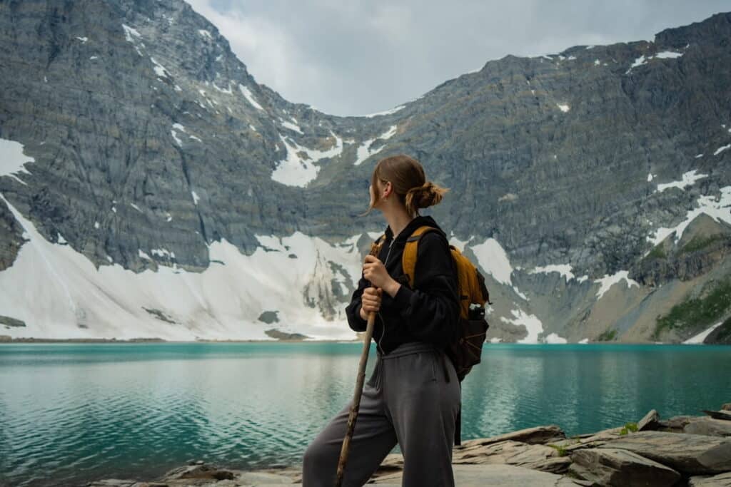 A woman standing on the banks of Lake Morraine in Banff.