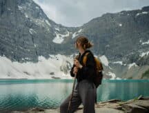 A woman standing on the banks of Lake Morraine in Banff.