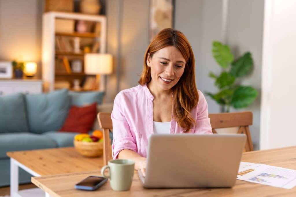 A woman sits at her laptop checking the next CRS score.