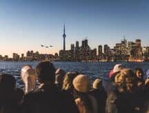 A group of people looking at the Toronto skyline.