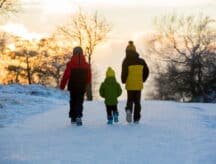 A group of children trudging through the winter snow.