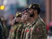 A group of soldiers standing in a row on remembrance day.