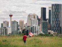 A boy looks out at the Calgary skyline.