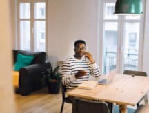 a guy talking on the phone while sitting on the chair