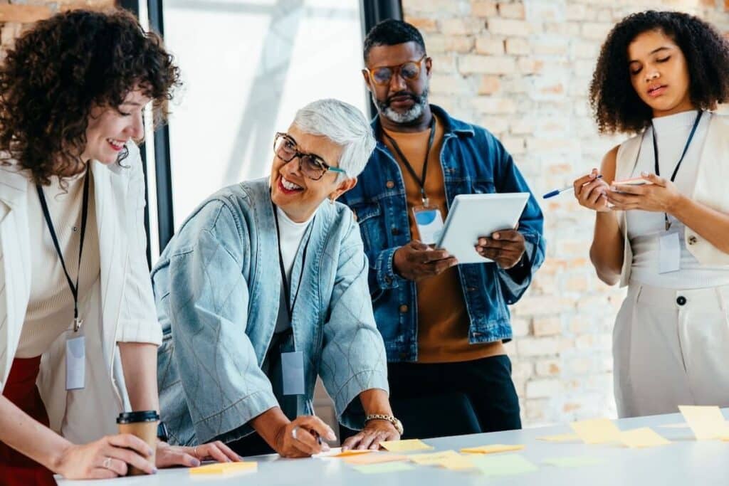 Team of workers in an office, using sticky notes.