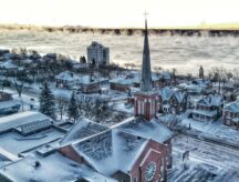 Homes and a church by Lake Simcoe in Ontario, during the winter