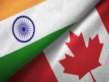 An Indian and Canadian flag folded against eachother.