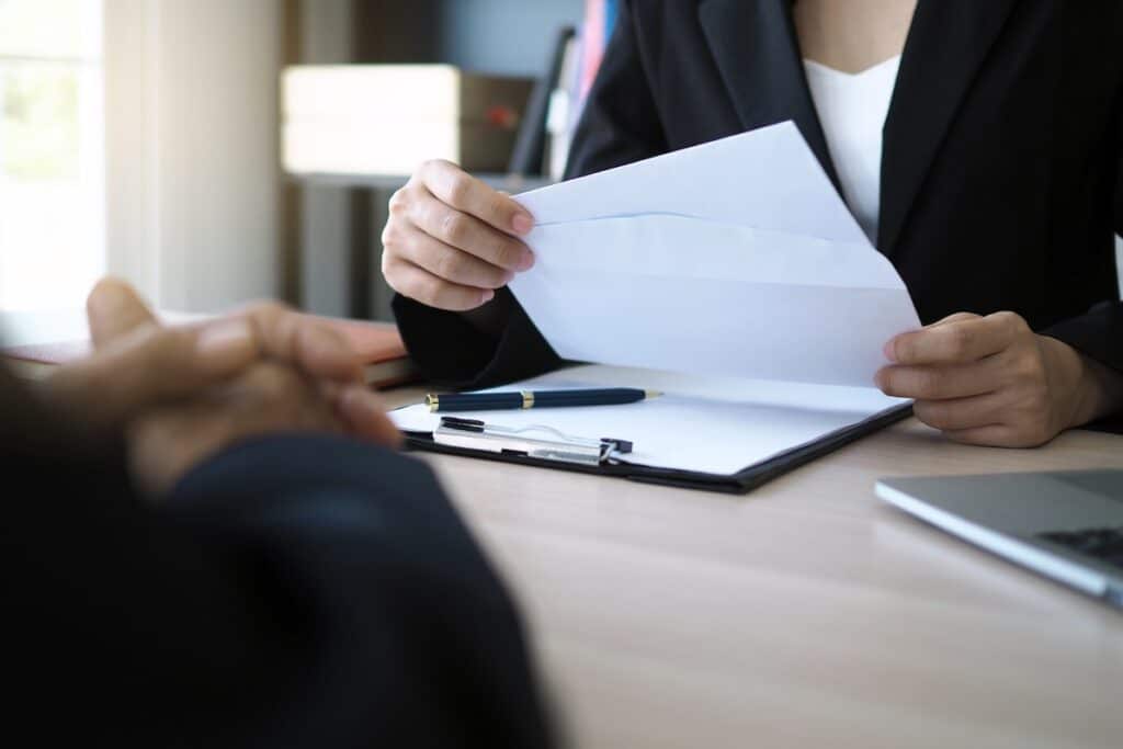 A person receives a job offer letter in person.