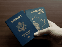 A person holds both a Canadian and American passport.