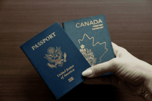 A person holds both a Canadian and American passport.