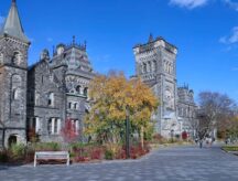 The University College Building at the University of Toronto, show in Autumn with changing foliage.