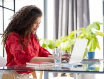 A woman works on her laptop