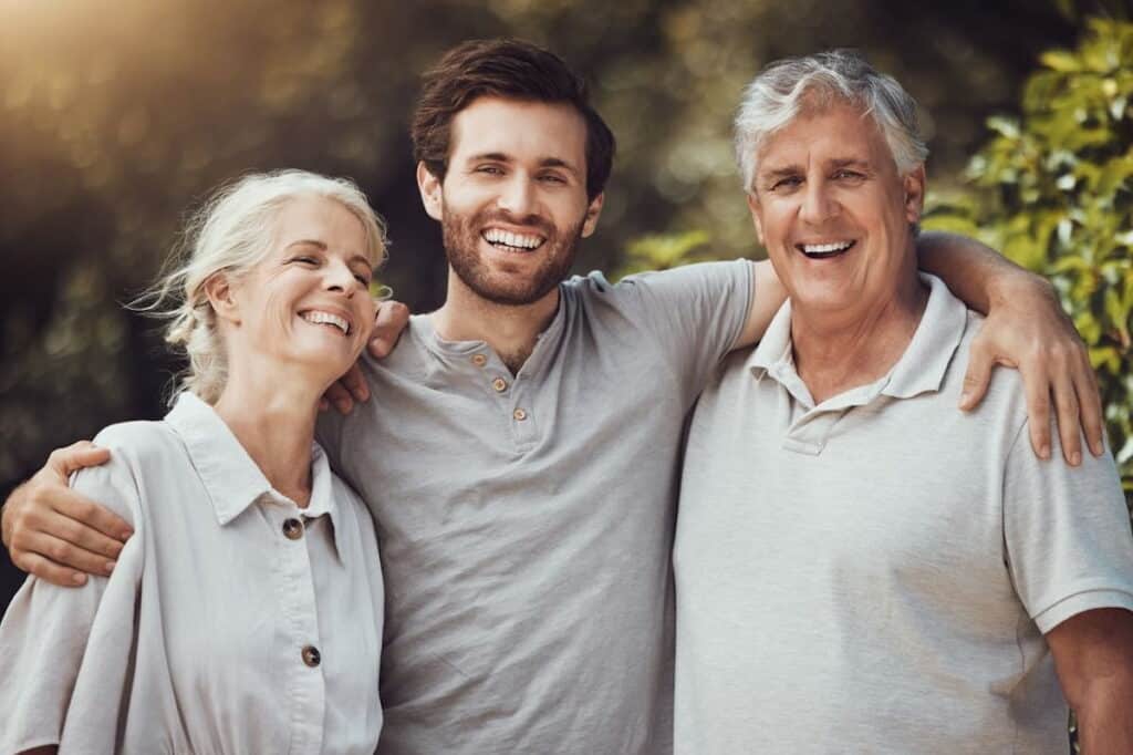 Smiling man with elderly parents