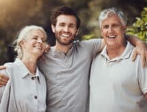 Smiling man with elderly parents