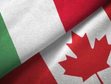 A closeup of the Italian and Canadian national flags against one another.
