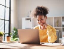 A woman checks the latest IRCC processing times.