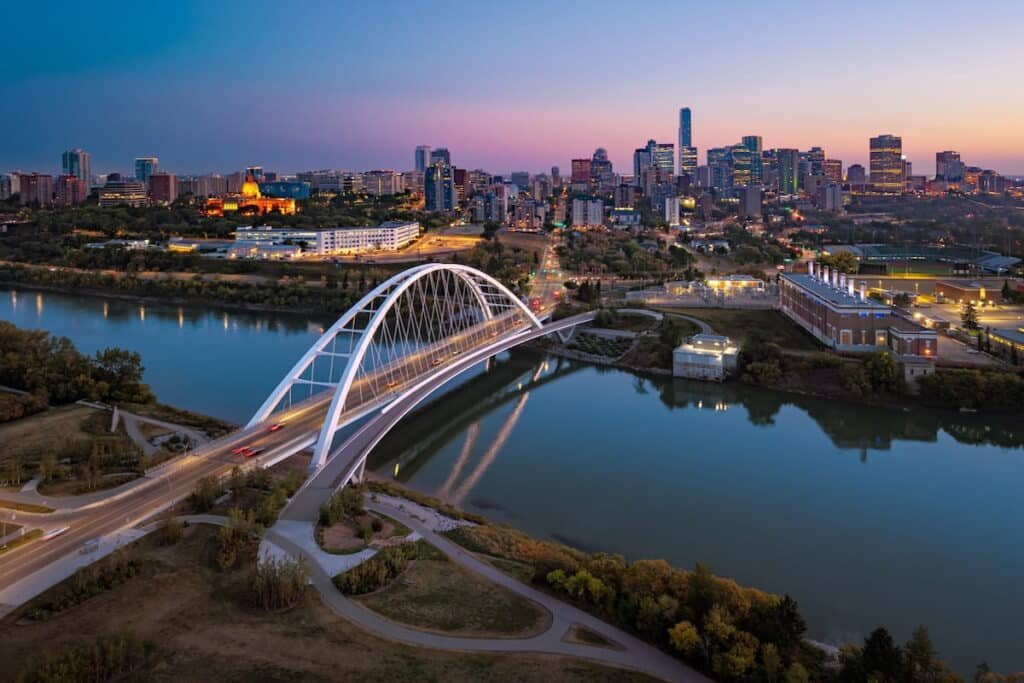 A view of Walterdale Bridge and downtown Edmonton skyline at dusk.