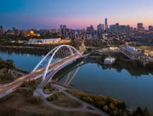 A view of Walterdale Bridge and downtown Edmonton skyline at dusk.