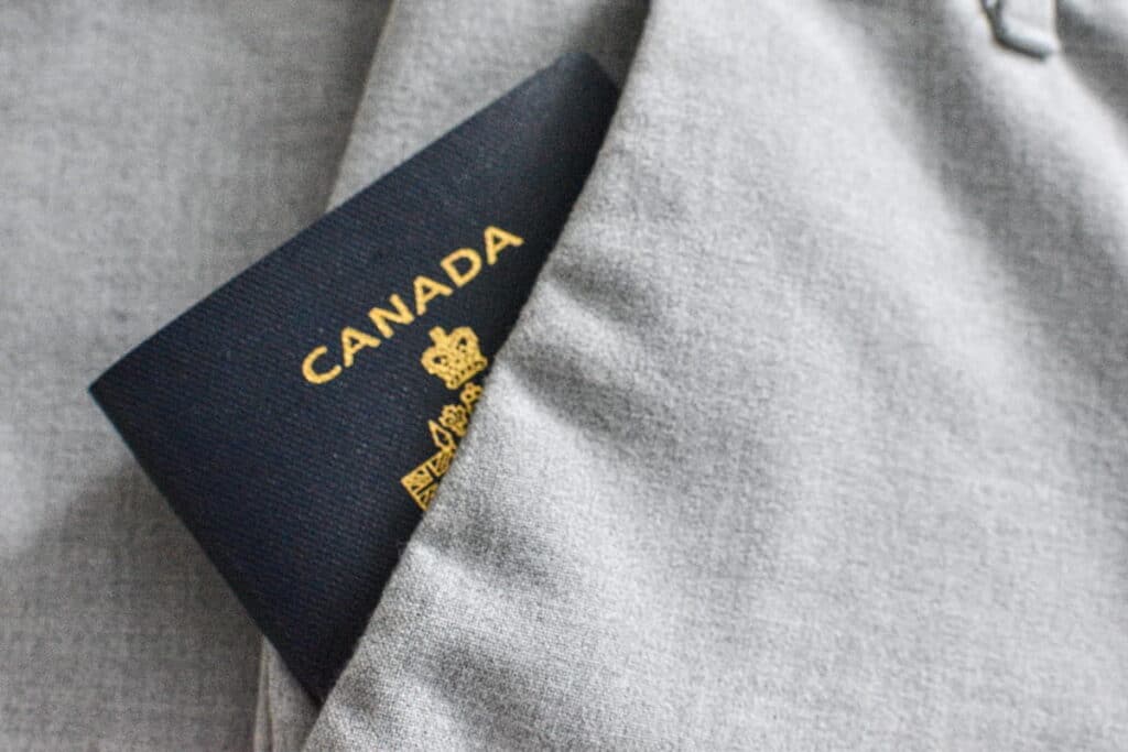 A picture of a Canadian passport tucked away in trouser pockets.