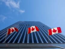 Canadian flag framed by buildings