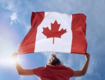 A young girl holds a Canadian flag
