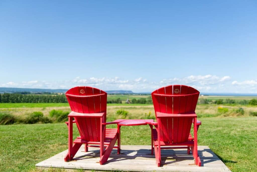 Red Adirondack chairs at Grand-Pré National Historic Site