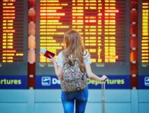 An international student studies the gate timings on her way to Canada.