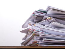 Stack of document paper with colorful paperclip place on wooden table