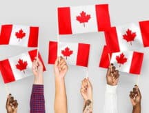 Hands waving Canadian flags
