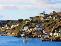 Houses, fishing sheds and stages on the hill side and along the coastline in The Battery, St. John's, Newfoundland and Labrador.