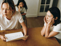 A family sits in quiet contemplation as they submit their proof of citizenship application to the Canadian government.