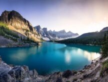Moraine Lake at sunset, with mountains visible in the background.
