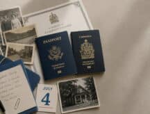 A chaotic table holding to passports and a number of scattered notes, as someone tries to trace back their family line to Canada.