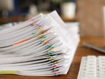 A stack of papers on a desk.
