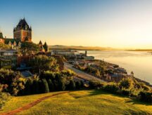 A view of the Chateau Frontenac surrounded by greenery in Quebec, Canada at sunrise