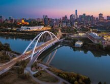 Aerial view of the Walterdale Bridge and the downtown Edmonton, Alberta skyline at dusk.