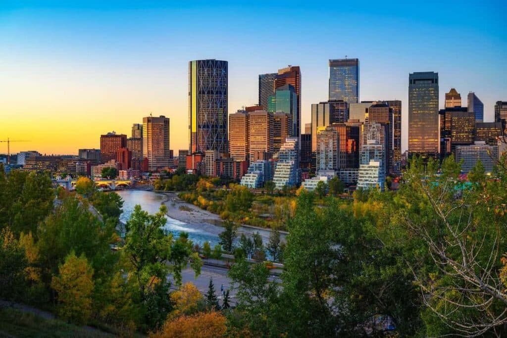 The Calgary, Alberta skyline at sunset, with Bow River rushing through.