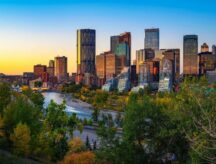 The Calgary, Alberta skyline at sunset, with Bow River rushing through.