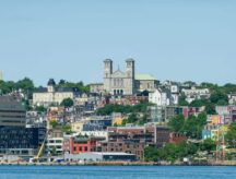 Colorful row houses viewed from Forth Amherst Road with St. John’s the Baptist Basilica rising behind.