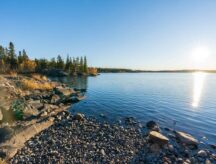 Frame Lake shore at sunset time, clear sky and sunlight. Yellowknife, Canada.