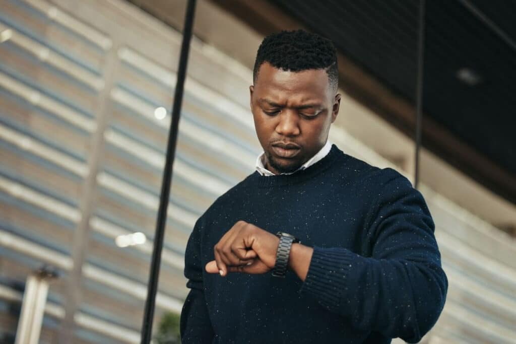 A man checking the time on his wristwatch.